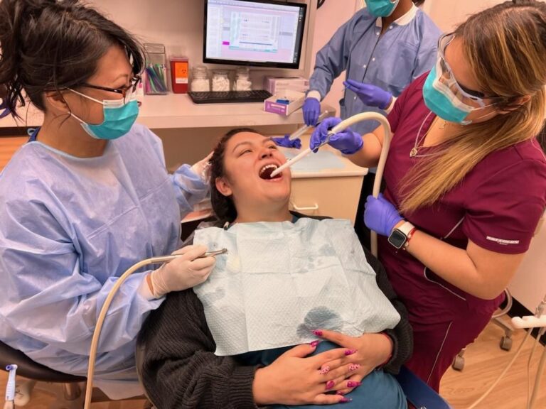 A patient receiving dental treatment from professionals.